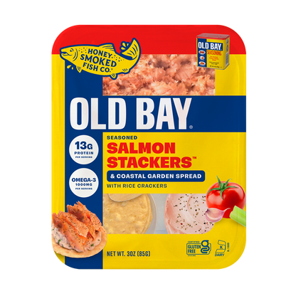 A 3 oz package of Old Bay Seasoned Salmon Stackers & Coastal Garden Spread with rice crackers, featuring a red, yellow, and blue design with food imagery and product details.