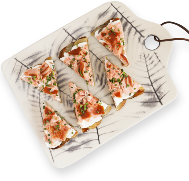 Salmon Pizza slices on a marble cutting board